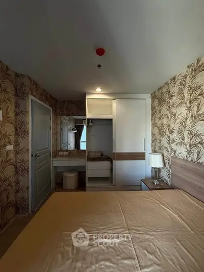 Cozy bedroom with stylish wallpaper and built-in wardrobe, perfect for modern living.