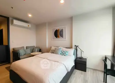 Modern bedroom with cozy seating area and stylish decor