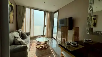 Stylish living room with ocean view, modern furniture, and elegant decor.