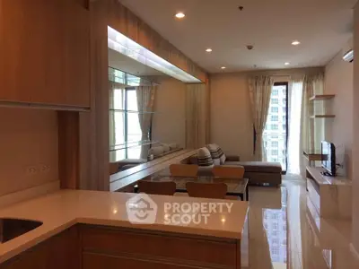 Modern living room with elegant decor and large windows in a high-rise apartment.
