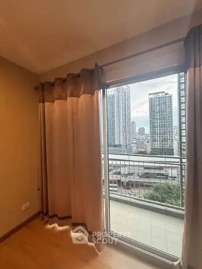 Spacious apartment with balcony offering stunning city views in modern high-rise building.