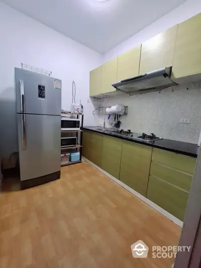 Modern kitchen with sleek cabinetry and gas stove in a compact layout