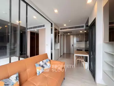 Modern living room with open kitchen and stylish decor in a contemporary apartment.
