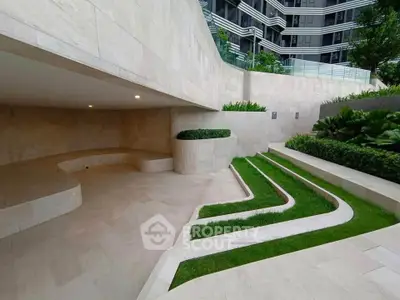 Modern building exterior with landscaped garden and stone pathways