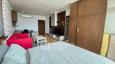 Modern studio apartment with stylish decor and open layout, featuring a cozy living area and bedroom.