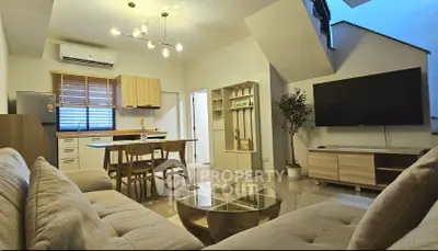 Modern open-plan living room with stylish furniture and natural light