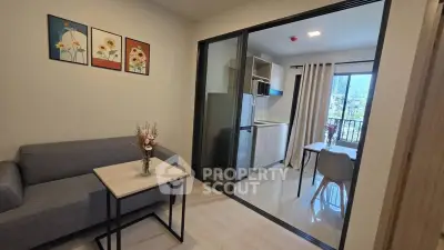 Modern apartment with cozy living room and open kitchen layout, featuring stylish decor and natural light.