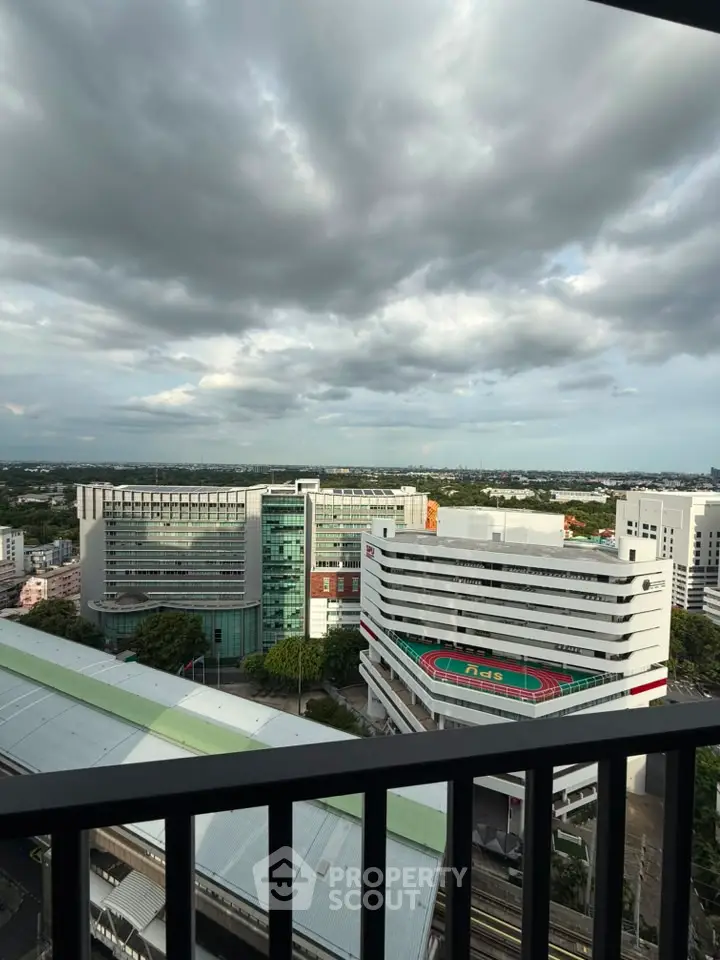Stunning cityscape view from a high-rise balcony with modern buildings and expansive skyline.