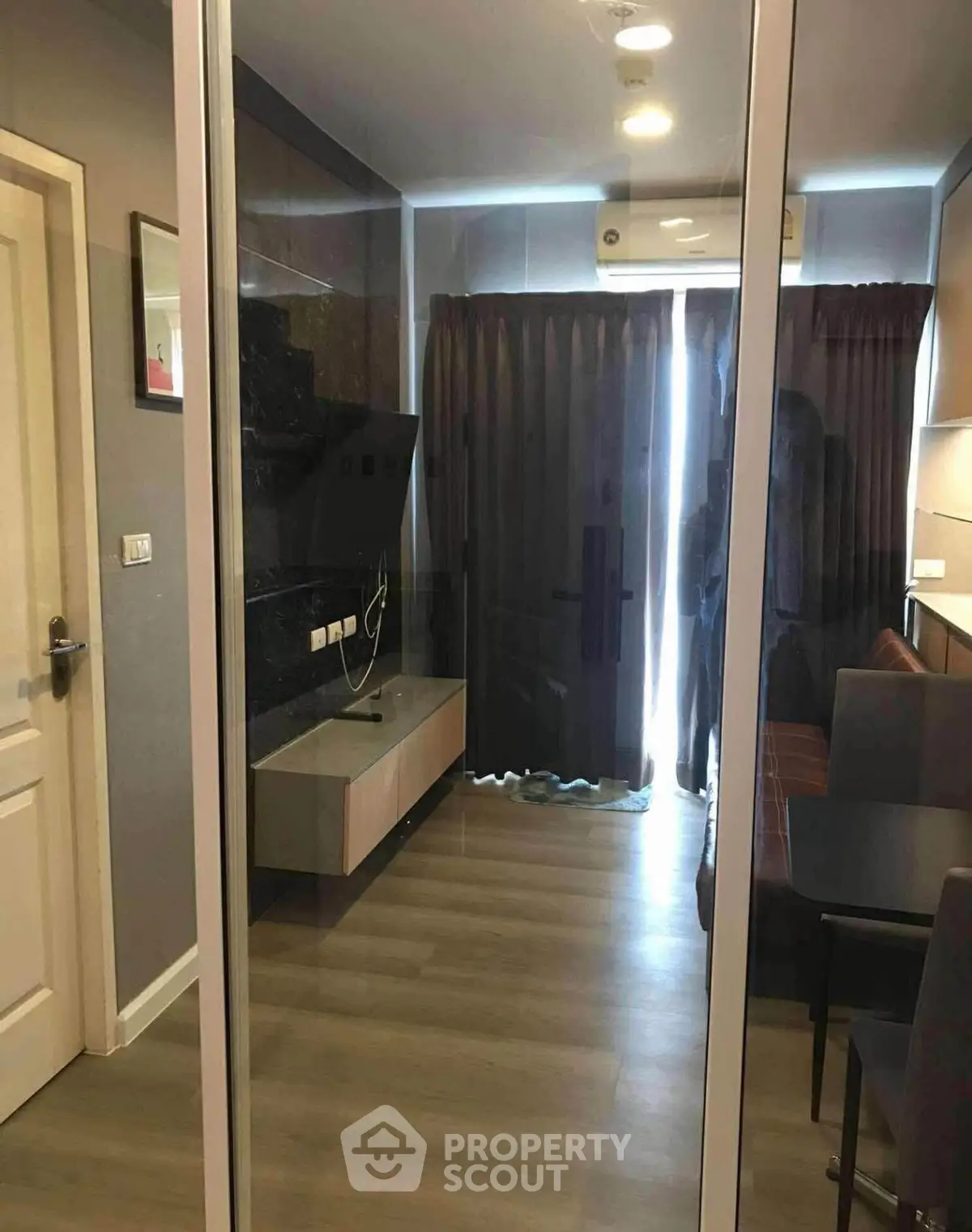 Modern living room with sleek design and floor-to-ceiling windows