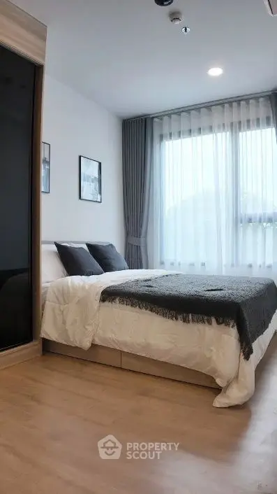 Modern bedroom with large window and stylish decor