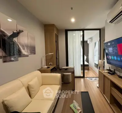 Modern living room with stylish decor and open layout leading to bedroom.