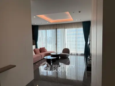 Luxurious modern living room with floor-to-ceiling windows and elegant furnishings.
