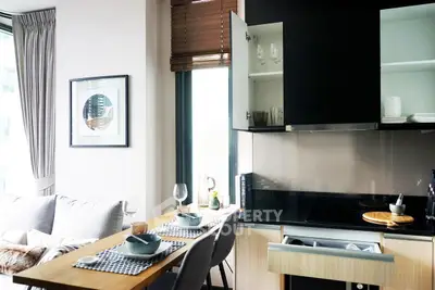 Modern open-layout kitchen and dining area with sleek cabinetry and stylish decor.
