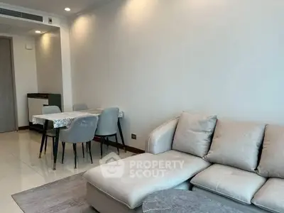 Modern living room with cozy sofa and dining area in open layout.