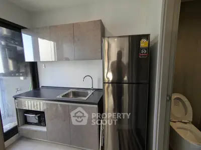 Modern kitchen with sleek cabinetry and stainless steel fridge