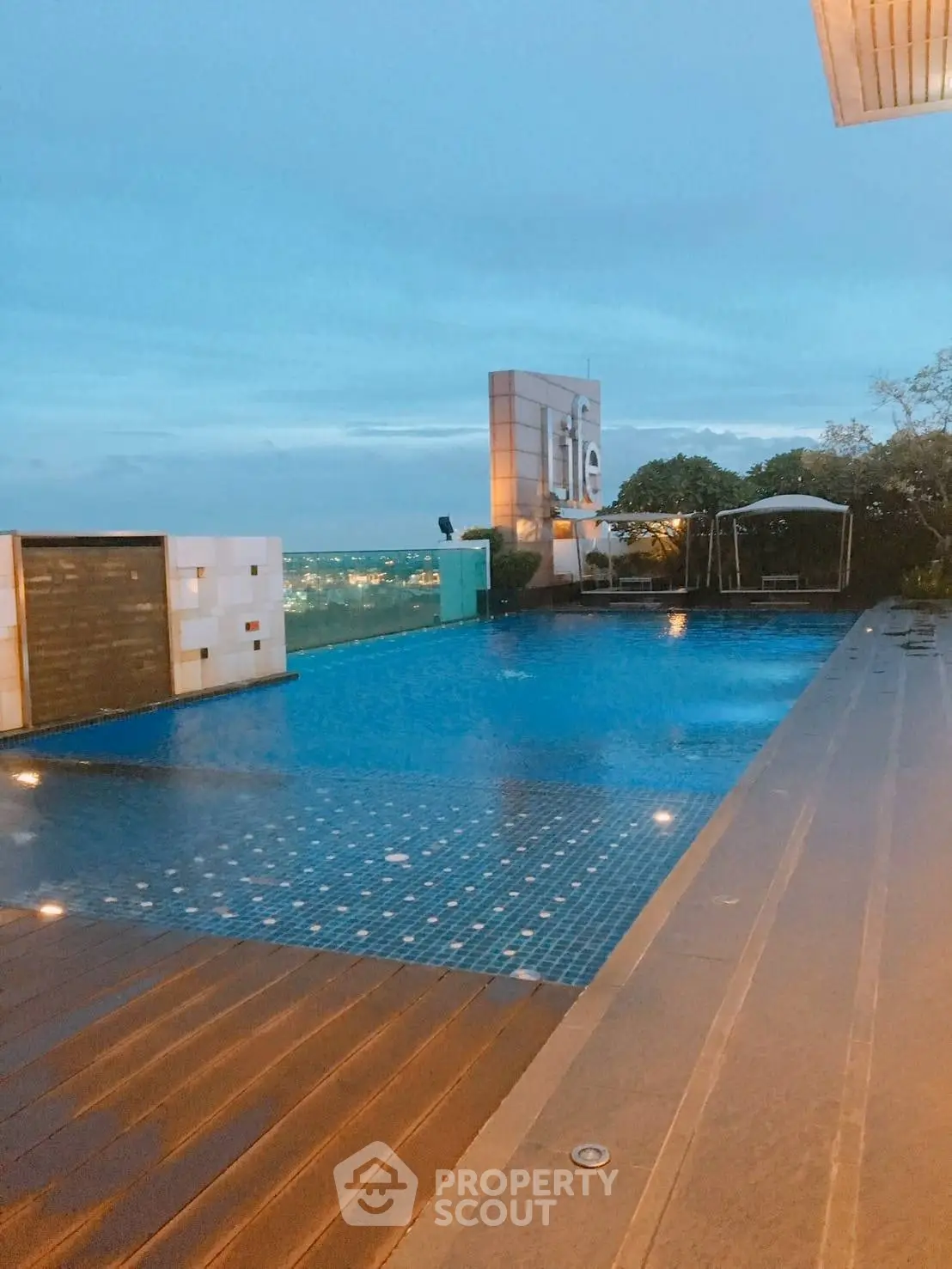 Luxurious rooftop pool with stunning city view at dusk