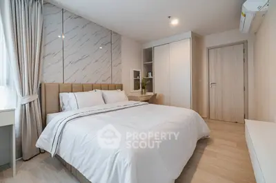 Modern bedroom with elegant decor and ample natural light