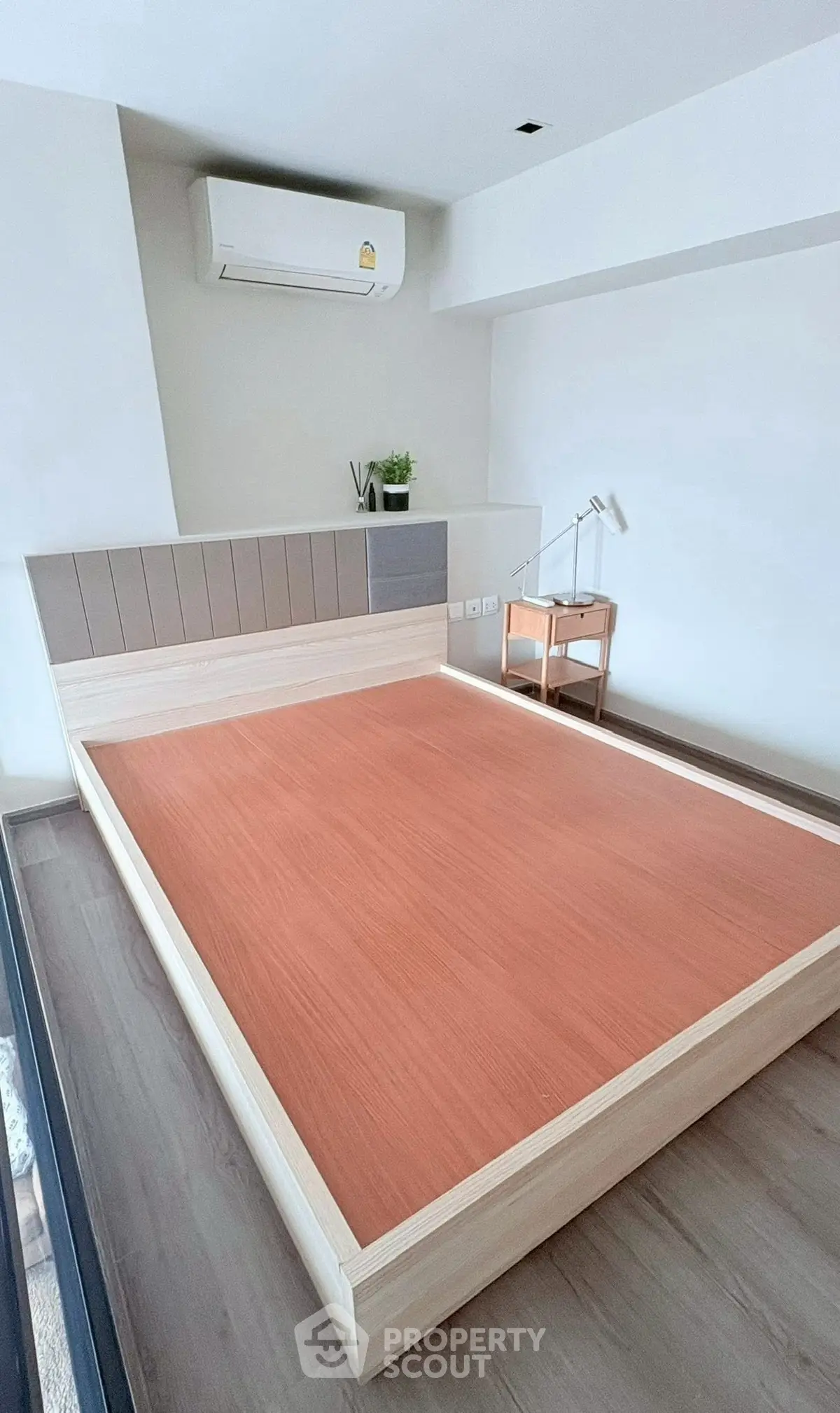 Modern bedroom with minimalist design and air conditioning unit