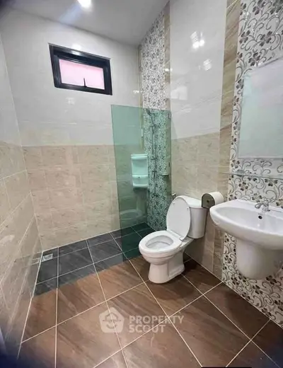 Modern bathroom with elegant tile design and glass shower enclosure