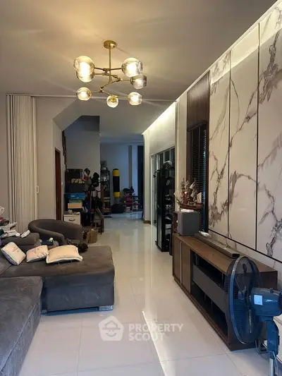Spacious living room with modern decor and elegant lighting