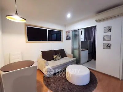 Cozy living room with modern decor and open kitchen layout