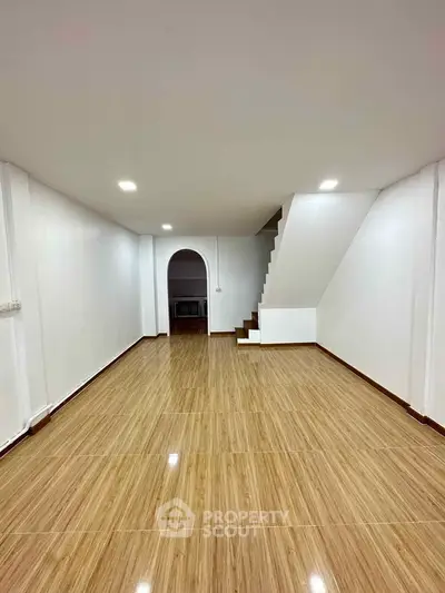 Spacious interior with wooden flooring and staircase, ideal for modern living.