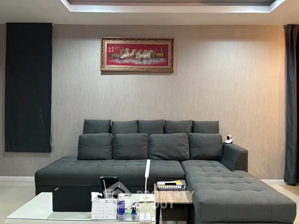 Modern living room with stylish sectional sofa and elegant wall art