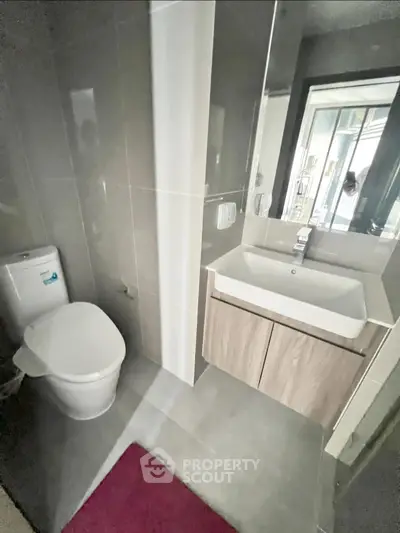 Modern bathroom with sleek fixtures and a large mirror