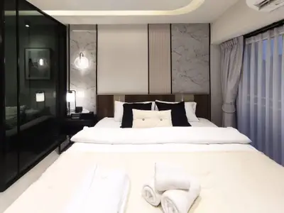Luxurious modern bedroom with elegant decor and plush bedding, perfect for relaxation and comfort.