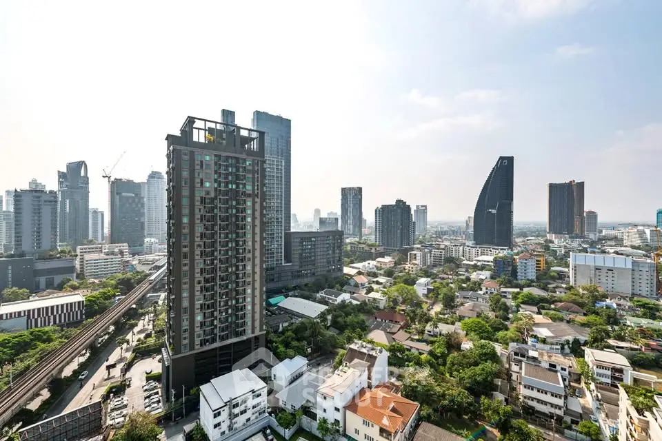 Stunning cityscape view showcasing modern high-rise buildings and lush greenery.