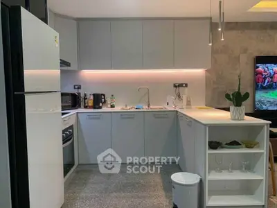 Modern kitchen with sleek cabinetry and integrated appliances in a stylish open layout.