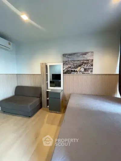 Cozy bedroom with modern decor and air conditioning, featuring a comfortable bed and stylish wall art.
