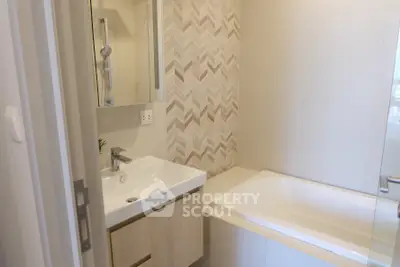 Modern bathroom with stylish tiles and bathtub in a contemporary home.