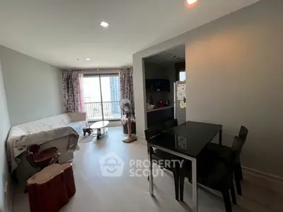 Modern living room with dining area and balcony view in a stylish apartment.
