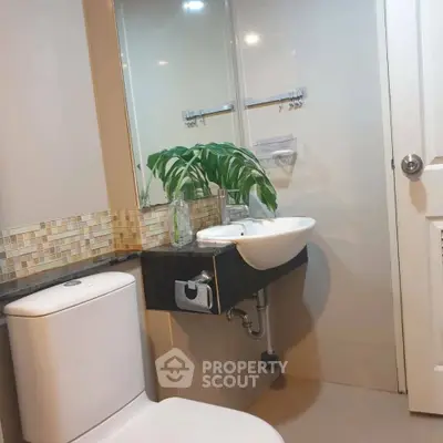 Modern bathroom with sleek fixtures and stylish tile accents, perfect for contemporary living.