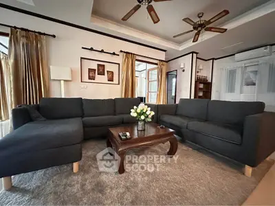 Spacious living room with elegant dark sofas and stylish decor