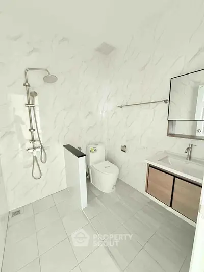 Modern bathroom with sleek fixtures and marble walls