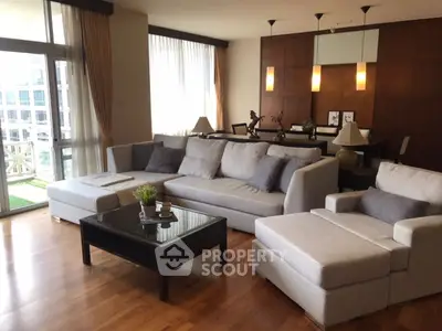 Spacious modern living room with elegant decor and large windows for natural light.