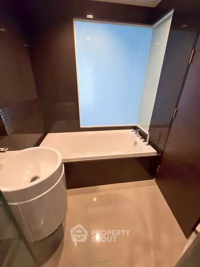 Modern bathroom with sleek bathtub and stylish fixtures in luxury apartment.