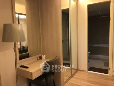 Modern bedroom with mirrored wardrobe and cozy lighting