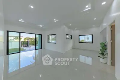 Spacious modern living room with large windows and balcony access