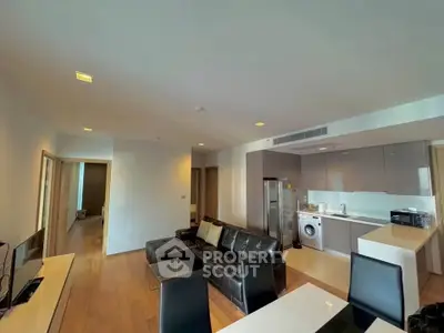 Modern open-layout living room with sleek kitchen and stylish furniture in a contemporary apartment.