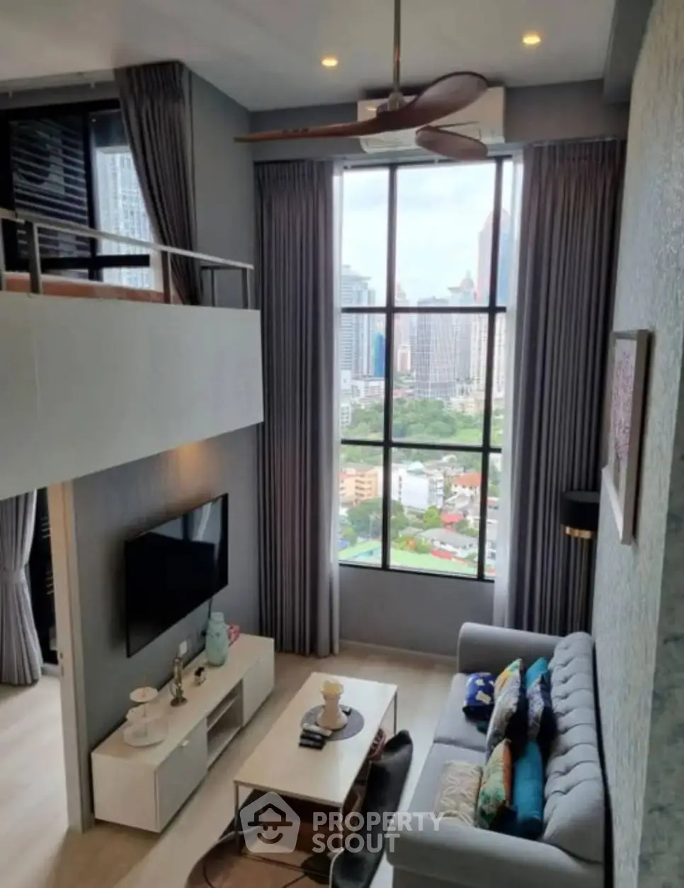 Modern loft apartment with high ceilings and stunning city view, featuring stylish living room and large windows.