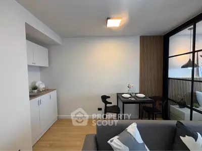 Modern living room with stylish dining area and sleek cabinetry
