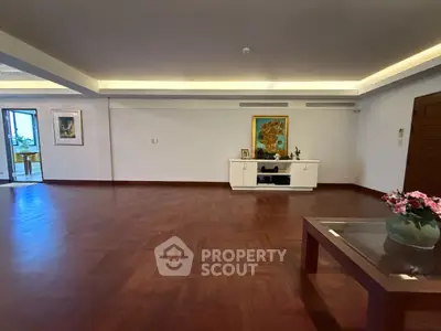 Spacious living room with elegant wooden flooring and modern decor