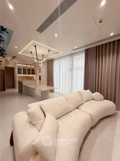 Luxurious modern living room with elegant sofa and open kitchen layout