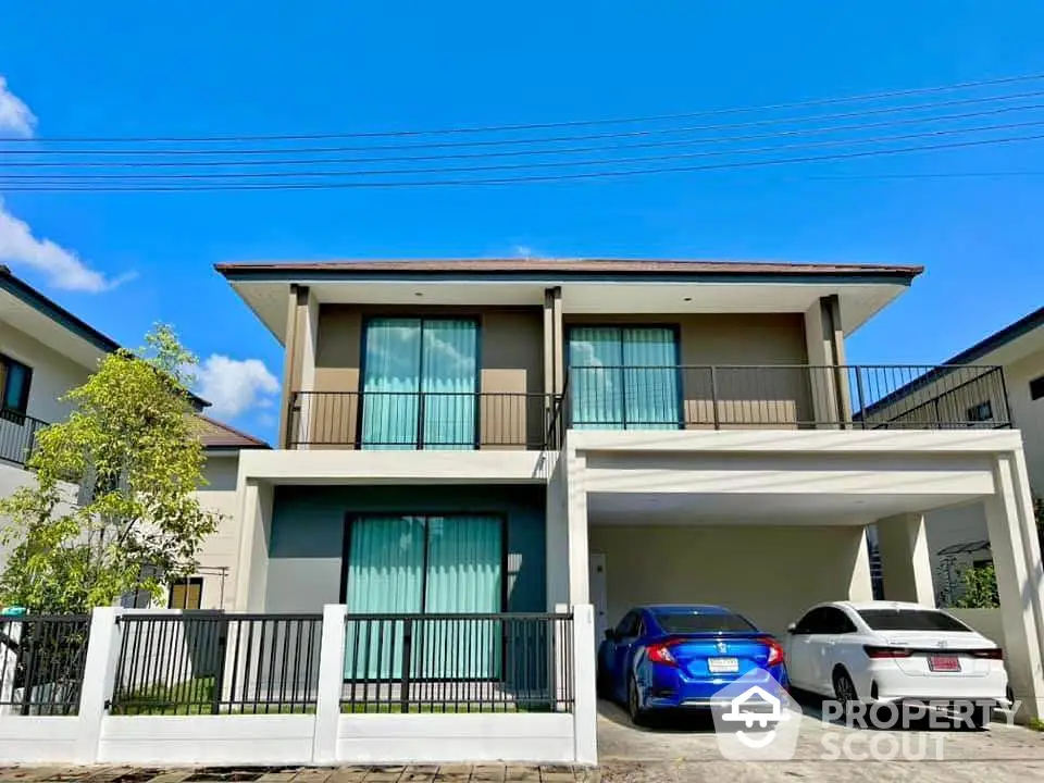 Modern two-story house with spacious driveway and sleek design in a suburban neighborhood.