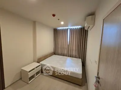 Cozy bedroom with modern design, featuring a comfortable bed and air conditioning, perfect for relaxation.