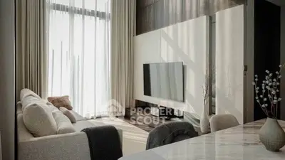 Modern living room with elegant decor and large windows for natural light.