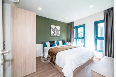 Modern bedroom with stylish decor and natural light